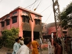 People gather at a church building vandalized by protesters in Jaranwala, Pakistan. 