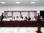 Defendants and lawyers attend a court hearing in the case of child deaths linked to contaminated cough syrups, in Tashkent, Uzbekistan.