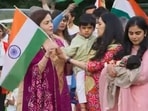 Nita Ambani handing the Indian flag to her grandson Prithvi. Nita Ambani handing the Indian flag to her grandson Prithvi.