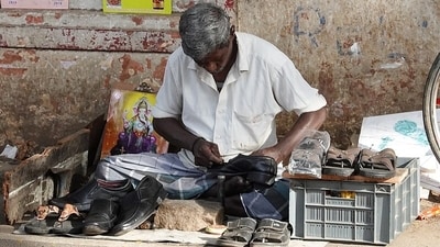 A cobbler fixing shoes on a roadside. (Wikimedia Commons) A cobbler fixing shoes on a roadside. (Wikimedia Commons)