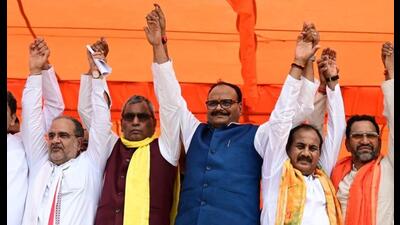Deputy CM Brajesh Pathak flanked by SBSP chief OP Rajbhar (L) and BJP candidate Dara Singh Chauhan (R) and others at a public meeting in Ghosi. (Sourced)