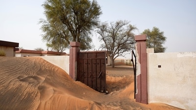 A house's entrance gate is buried under the sand at the Bedouin village of al-Ghuraifa, about 100 km, 62 miles, southeast of Sharjah, United Arab Emirates. Built-in the 1970s, the village was abandoned two decades later as oil wealth transformed the country into a global hub of commerce and tourism, home to the futuristic cities of Dubai and Abu Dhabi. (AP Photo/Kamran Jebreili) A house's entrance gate is buried under the sand at the Bedouin village of al-Ghuraifa, about 100 km, 62 miles, southeast of Sharjah, United Arab Emirates. Built-in the 1970s, the village was abandoned two decades later as oil wealth transformed the country into a global hub of commerce and tourism, home to the futuristic cities of Dubai and Abu Dhabi. (AP Photo/Kamran Jebreili)