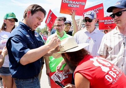 FILE PHOTO: Republican U.S. presidential candidate and Florida Governor Ron DeSantis signs a supporter's hat, as he campaigns at the Iowa State Fair in Des Moines, Iowa, U.S. August 12, 2023. REUTERS/Scott Morgan/File Photo (REUTERS)