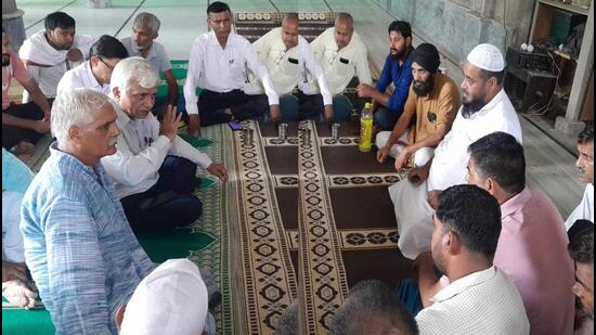 Local community members holding a meeting at the mosque in Samalkha on Wednesday after the incident Tiranga Yatra triggered communal tension. (HT Photo)