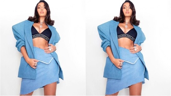 Her outfit comes in light blue and features an oversized blazer with full padded sleeves and a double collar. She accessorised with a chic black deep v-neck bralette for a sexy look. Paired with a matching mini skirt with an uneven hem, she looked like a true diva.(Instagram/@norafatehi)