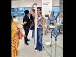IKEA shopper in Hyderabad store posing with a bill as tall as her. IKEA shopper in Hyderabad store posing with a bill as tall as her.