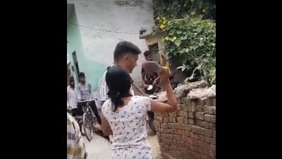 A screengrab from the video showing the girl hitting the man. (HT Photo) A screengrab from the video showing the girl hitting the man. (HT Photo)