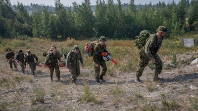 Canadian Armed Forces soldiers head to the forest to construct a firebreak behind Parker Recreation Field in Yellowknife to help fight wildfires (AP) Canadian Armed Forces soldiers head to the forest to construct a firebreak behind Parker Recreation Field in Yellowknife to help fight wildfires (AP)