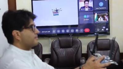 Civil aviation minister Jyotiraditya Scindia flies the national flag using a drone.