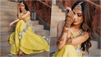 Mouni looked stunning for her mehendi in a yellow outfit and chunky jewellery. Her bridal mehendi was designed by Halima Khan and features her husband's initials. Mouni ditched heavy designs in favour of Arabic patterns with bold, larger motifs and more negative space. She also covered her fingertips and parts of her hand, leaving some areas free of henna. (Instagram ) Mouni looked stunning for her mehendi in a yellow outfit and chunky jewellery. Her bridal mehendi was designed by Halima Khan and features her husband's initials. Mouni ditched heavy designs in favour of Arabic patterns with bold, larger motifs and more negative space. She also covered her fingertips and parts of her hand, leaving some areas free of henna. (Instagram )