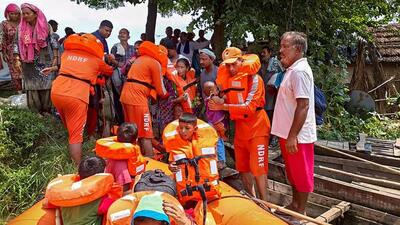 National Disaster Response Force personnel rescuing residents stranded in flood-affected Tiora village in Kangra district of Himachal Pradesh on Thursday. (PTI Photo)
