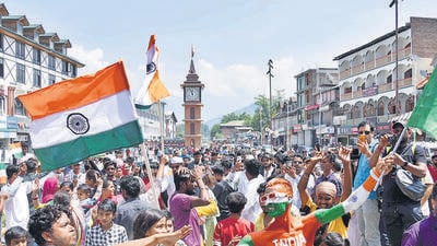 People gather in front of the newly renovated Clock Tower at Lal Chowk in Srinagar on Independence Day. (ANI)