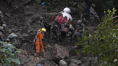 Rescuers searching the debris for survivors after a landslide following heavy rainfall in Shimla on Thursday. (AP Photo)