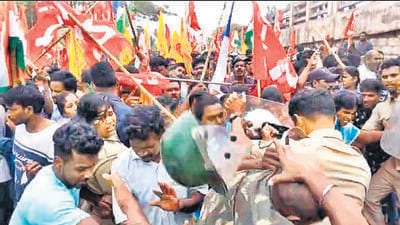 The police erected barbed wire fencing on both sides of the gate, but the workers of Adani Gangavaram port in Visakhapatnam tried to cross the fence and enter the premises, leading to clashes between the workers and the police. (HT Photo) The police erected barbed wire fencing on both sides of the gate, but the workers of Adani Gangavaram port in Visakhapatnam tried to cross the fence and enter the premises, leading to clashes between the workers and the police. (HT Photo)