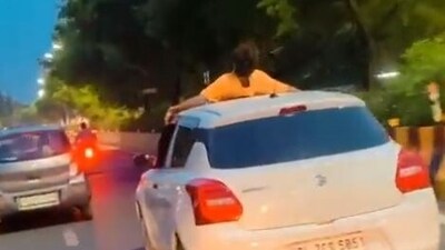 Man performing stunt on roof of moving car in Noida (Twitter)