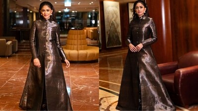 Her outfit comes in a rusty brown colour and features full sleeves, a short neck, a fitted buttoned bodice and an open slit at the front. Her jacket-style kurta gown is truly a show-stopping look. (Instagram/@mrunalthakur) Her outfit comes in a rusty brown colour and features full sleeves, a short neck, a fitted buttoned bodice and an open slit at the front. Her jacket-style kurta gown is truly a show-stopping look. (Instagram/@mrunalthakur)