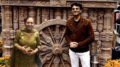Vikas Khanna along with his mother in front of the Konark wheel replica. Vikas Khanna along with his mother in front of the Konark wheel replica.