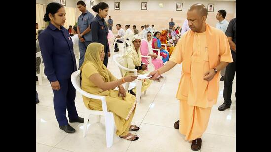 Chief minister Yogi Adityanath listens to the grievances of people from different districts during the ‘Janata Darshan’ conducted at CM’s residence, in Lucknow on Thursday. (ANI Photo)