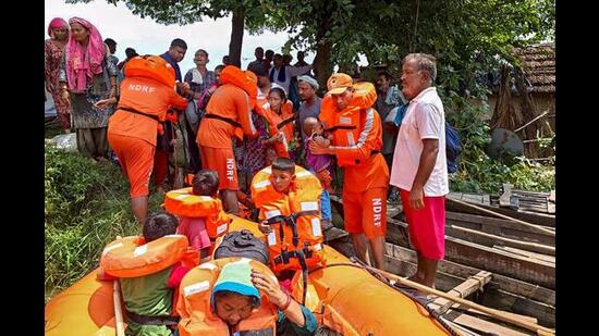 DRF personnel rescue residents stranded in flood-affected areas of Tiora village in Kangra district. (PTI)