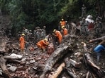 Rescue workers remove the debris as a search operation continues in the aftermath of a landslide following torrential rain in Shimla
