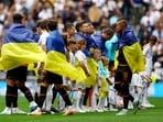 Shakhtar Donetsk's Oleksandr Zubkov and teammates wear the flag of Ukraine before the match