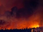 A helicopter battles the McDougall Creek wildfire as it burns in the hills West Kelowna, British Columbia, Canada, A helicopter battles the McDougall Creek wildfire as it burns in the hills West Kelowna, British Columbia, Canada,