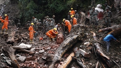 Rescue workers remove the debris as a search operation continues in the aftermath of a landslide following torrential rain in Shimla (REUTERS)