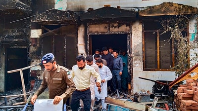 Police and administration officials visit a church vandalised by a mob at Jaranwala, in Faisalabad (PTI) Police and administration officials visit a church vandalised by a mob at Jaranwala, in Faisalabad (PTI)