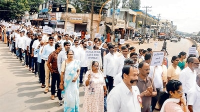 People during a protest march against the violence, on Friday. (PTI) People during a protest march against the violence, on Friday. (PTI)