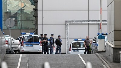 Police officers stand guard at the scene of the wreckage of a drone at the "Moscow City" business district after a reported drone attack in Moscow, Russia on Friday. (AP)