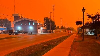 TOPSHOT - This handout photo shows the town of Fort Smith, Canada during the wildfires, on August 13, 2023. Hundreds of people started to be airlifted to safety from remote villages threatened by wildfires in Canada's far north overnight Monday to Tuesday after Yellowknife, the largest city in the region, declared an emergency. (Photo by Handout / AFP) / RESTRICTED TO EDITORIAL USE - MANDATORY CREDIT "AFP PHOTO / Dana Fergusson" - NO MARKETING - NO ADVERTISING CAMPAIGNS - DISTRIBUTED AS A SERVICE TO CLIENTS / TO GO WITH AFP STORY BY Genevi�ve NORMAND "Military airlifts provide escape as wildfires sweep Canada's far north" (AFP)