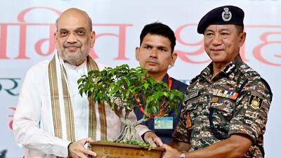 Union home minister Amit Shah being presented with a sapling by Central Reserve Police Force Director General Sujoy Lal Thaosen during an event, on Friday (ANI) Union home minister Amit Shah being presented with a sapling by Central Reserve Police Force Director General Sujoy Lal Thaosen during an event, on Friday (ANI)