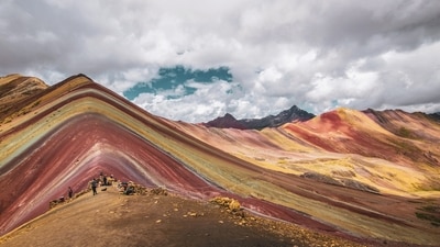 Rainbow Mountains, Peru: Vinicunca, often called Winikunka or Rainbow Mountain, is an impressive geological feature due to its vibrant stripes made up of layers of 14 different minerals. A popular detour for tourists travelling to and from the ruins of Machu Picchu, the mountain is located in the Andes near the city of Cusco. It is, however, a beautiful sight to see with your own eyes and capture in your lenses. Even on a cloudy day, the mountain's distinctive and unusual mineral streaks are visible, making it anything but dull.&nbsp; (Unsplash/McKayla Crump)