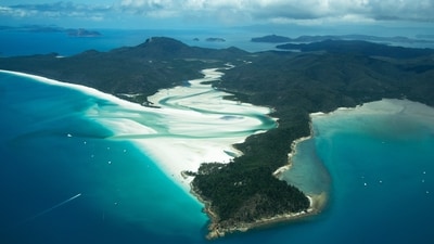Whitehaven Beach, Queensland, Australia: Whitsunday Island, the biggest of the 74 islands in the Whitsundays, is home to the award-winning, immaculate Whitehaven Beach. The beach is seven miles long and has some of the finest, brightest white silica sand in the world. You'll quickly see why people come from all over the world as you sink your feet into the sand and wade into the warm waves that lazily lap the shore. (Unsplash/Sofia Cerqueira)