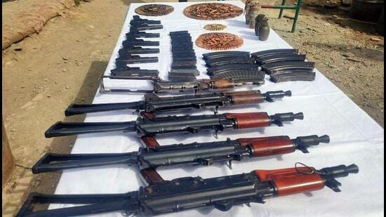 A cache of arms and ammunition, including five AK rifles, seven pistols and four hand-grenades, was recovered during a joint operation by the Indian Army, Border Security Force and Jammu and Kashmir Police in the Machil sector of Kupwara on Friday. (ANI Photo)