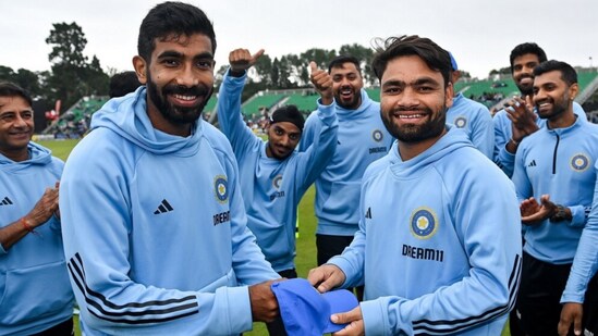 Jasprit Bumrah handing over the India cap to Rinku Singh