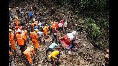 Rescue workers and locals remove the debris during a search for survivors after a landslide following torrential rains, in Shimla, Saturday. (PTI)