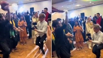 The image shows a cameraman dancing with a wedding guest. (Twitter/@PunjabiTouch) The image shows a cameraman dancing with a wedding guest. (Twitter/@PunjabiTouch)