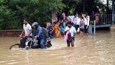 Severe waterlogging forced commuters on Saturday morning to walk through muddy waters. (Photo by Parveen Kumar/Hindustan Times) Severe waterlogging forced commuters on Saturday morning to walk through muddy waters. (Photo by Parveen Kumar/Hindustan Times)
