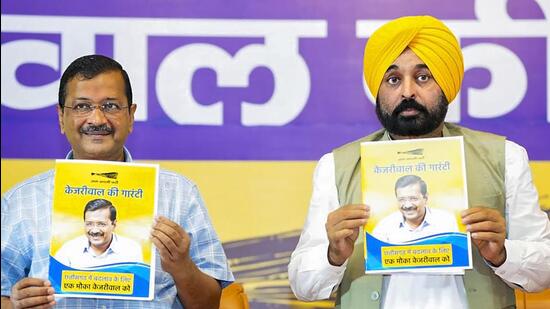 Delhi chief minister Arvind Kejriwal and Punjab CM Bhagwant Mann during a public meeting, in Raipur on Saturday. (PTI)