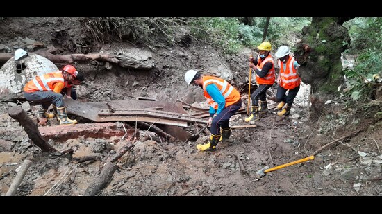 Rescue and search operation is underway by National Disaster Response Force (NDRF) personnel in the landslide-affected areas after heavy rainfall, in Shimla on Saturday. (ANI)