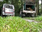 Leopard, rescued by forest officials, sitting inside a van. Leopard, rescued by forest officials, sitting inside a van.