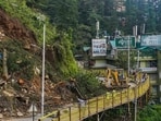 Shimla: Heavy Machineries being used to remove trees from the Cart Road following recent monsoon rains, in Shimla, Saturday.