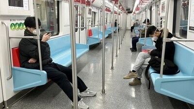Commuters wearing face masks ride a subway train in China. (Reuters) Commuters wearing face masks ride a subway train in China. (Reuters)