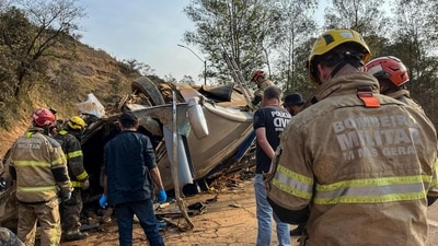 Firemen working at the scene of an accident after a bus carrying fans of Brazilian football team Corinthians overturned on a highway in Igarape. (AFP)