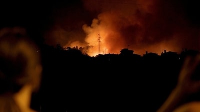 Spain Wildfire: People watch wildfire burning in Ravelo, Tenerife, Canary Islands, Spain. (Reuters)