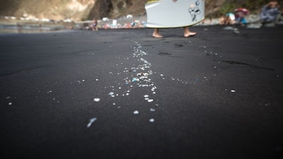 Microplastics and mesoplastic debris are pictured at the Almaciga Beach, on the north coast of the Canary Island of Tenerife, on July 14, 2018, during a cleaning operation organized by the NGO 'Canarias Libre de Plasticos' (Canary Islands free of plastics). (AFP)