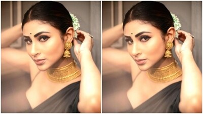 Mouni further accessorised her look for the day in a traditional golden neck choker and golden jhumkas from the house of Amnol Jewellers. (Instagram/@imouniroy) Mouni further accessorised her look for the day in a traditional golden neck choker and golden jhumkas from the house of Amnol Jewellers. (Instagram/@imouniroy)
