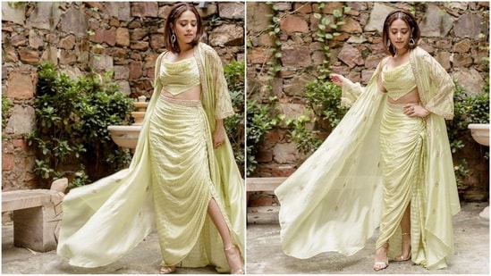 Her outfit features a mint cape in satin silk and an organza silk base with Mardi work. It is paired with a matching cowl top and a draped skirt having hand embellishment belt detail.&nbsp;(Instagram/@nushrrattbharuccha)
