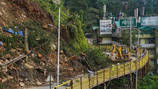 Shimla: Heavy Machineries being used to remove trees from the Cart Road following recent monsoon rains, in Shimla, Saturday. (PTI)